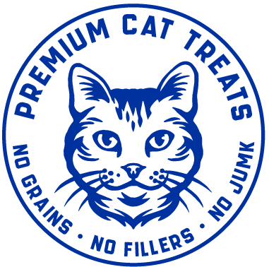 A circular blue and white logo featuring a stylized cat face with the text 'PREMIUM CAT TREATS' around the top arc and 'NO GRAINS • NO FILLERS • NO JUNK' along the bottom.