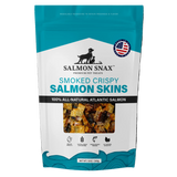 A package of Salmon Snax Smoked Crispy Salmon Skins, with an image of the product in a clear window, indicating it is a pet treat made from smoked and crispy salmon skins.